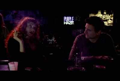 Marlena (Nicole LaLiberte) helps Dylan (Callum Blue) drink hard and smoke in SCHISM.